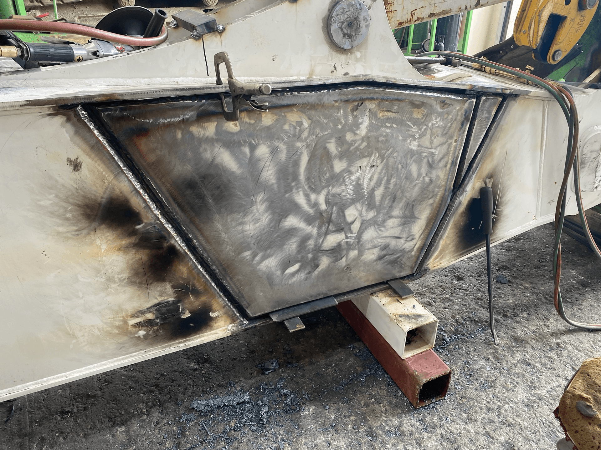 Structural welding repair of Volvo excavator boom performed to OEM standards at certified fabrication facility