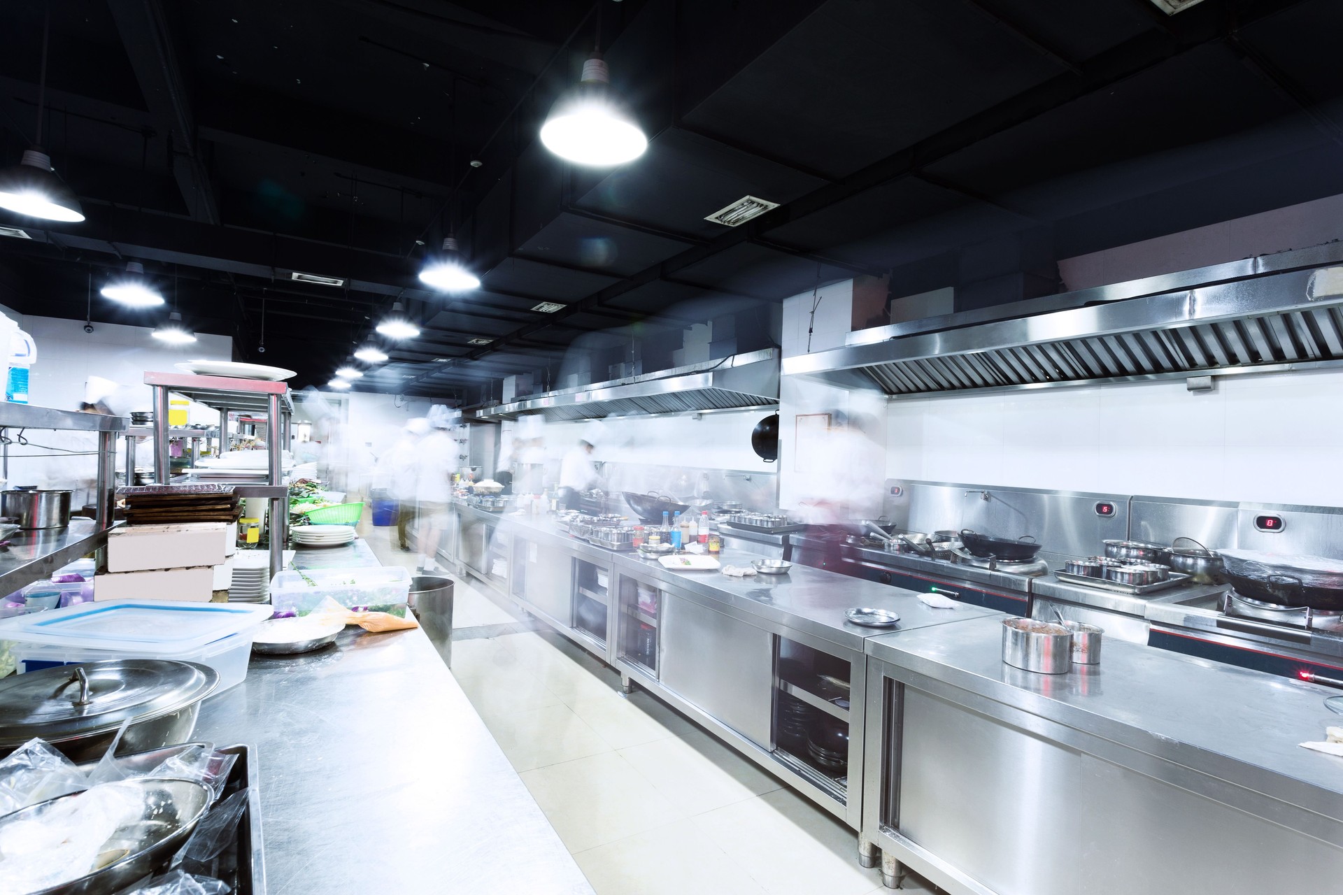Certified welder fabricating stainless steel frame with TIG process in commercial shop setting for food-grade and architectural use